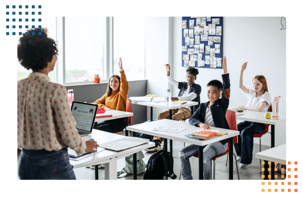 teacher stands at the front of a classroom with middle school students