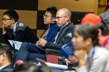 college students in an auditorium paying attention to the lecturer